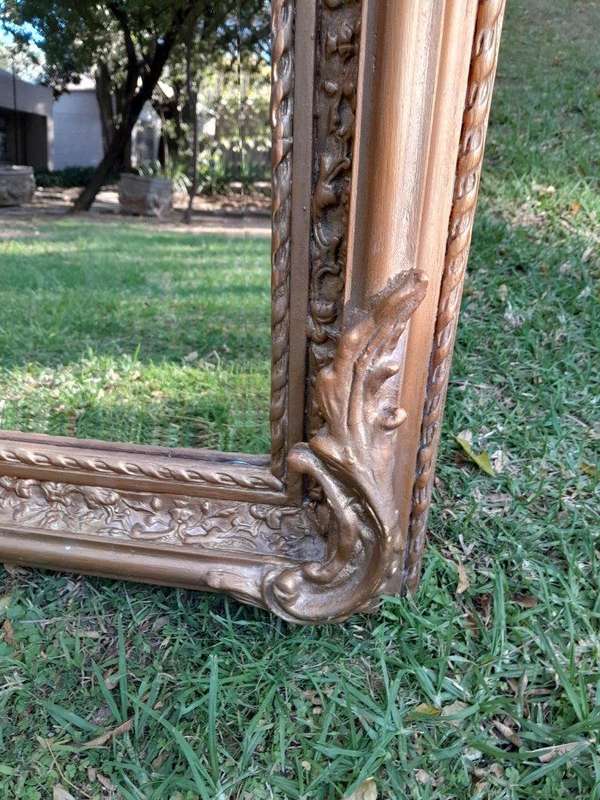 A French Rococo Style Ornately Carved & Gilded Bevelled Mirror
