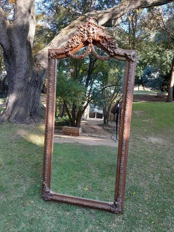 A French Rococo Style Ornately Carved & Gilded Bevelled Mirror