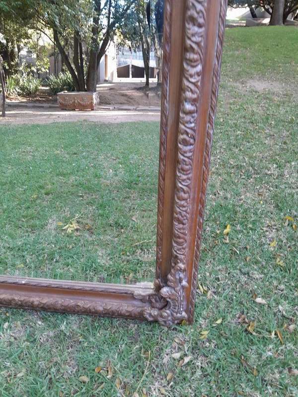 A French Rococo Style Ornately Carved & Gilded Bevelled Mirror