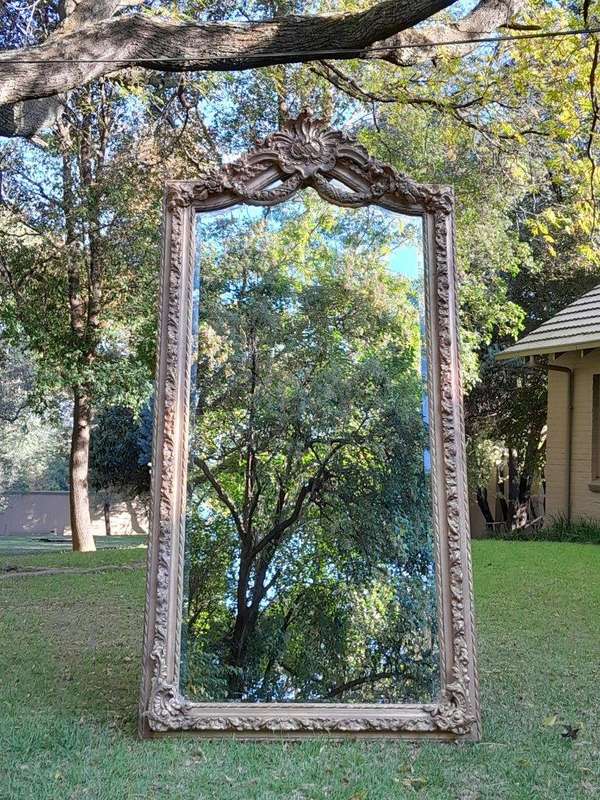 A French Rococo Style Ornately Carved & Gilded Bevelled Mirror