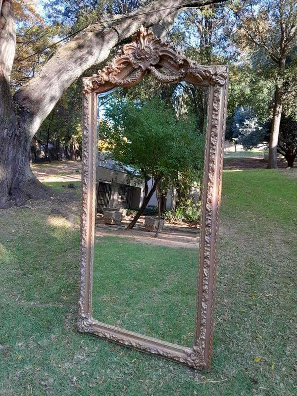 A French Rococo Style Ornately Carved & Gilded Bevelled Mirror
