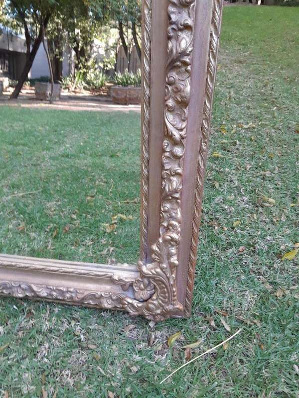 A French Rococo Style Ornately Carved & Gilded Bevelled Mirror