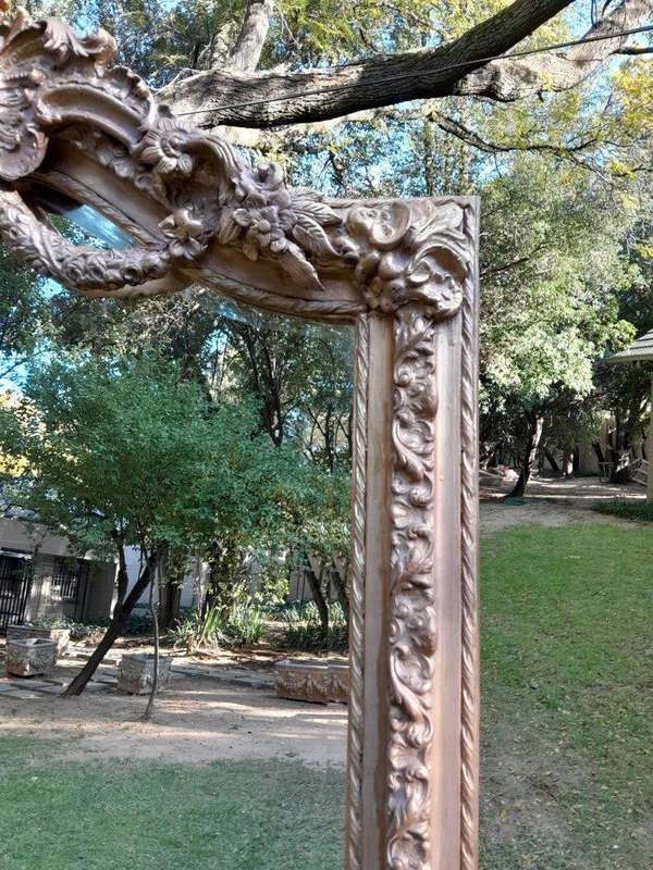 A French Rococo Style Ornately Carved & Gilded Bevelled Mirror