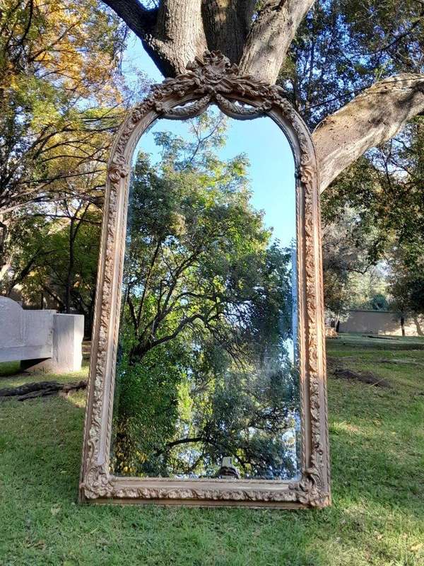 A French Rococo Style Ornately Carved & Gilded Bevelled Mirror