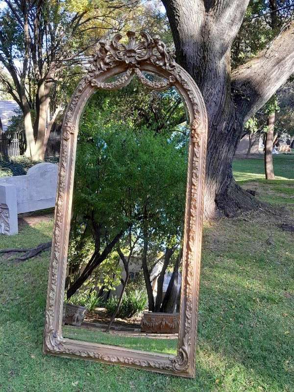 A French Rococo Style Ornately Carved & Gilded Bevelled Mirror