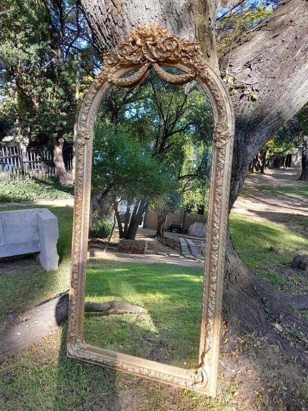 A French Rococo Style Ornately Carved & Gilded Bevelled Mirror