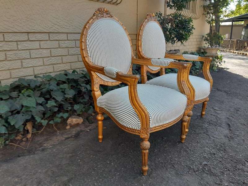 A 20TH Century French Style Pair Of Ornately Carved Giltwood Armchairs