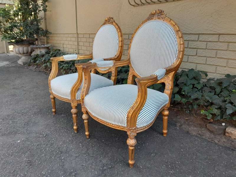 A 20TH Century French Style Pair Of Ornately Carved Giltwood Armchairs