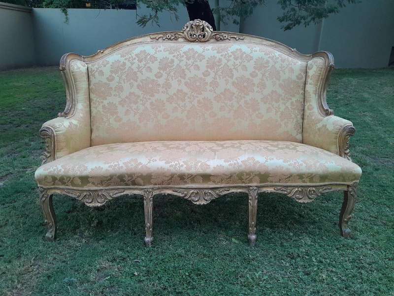 An Early 20th Century French Style Ornately Carved and Gilded Wingback Settee 