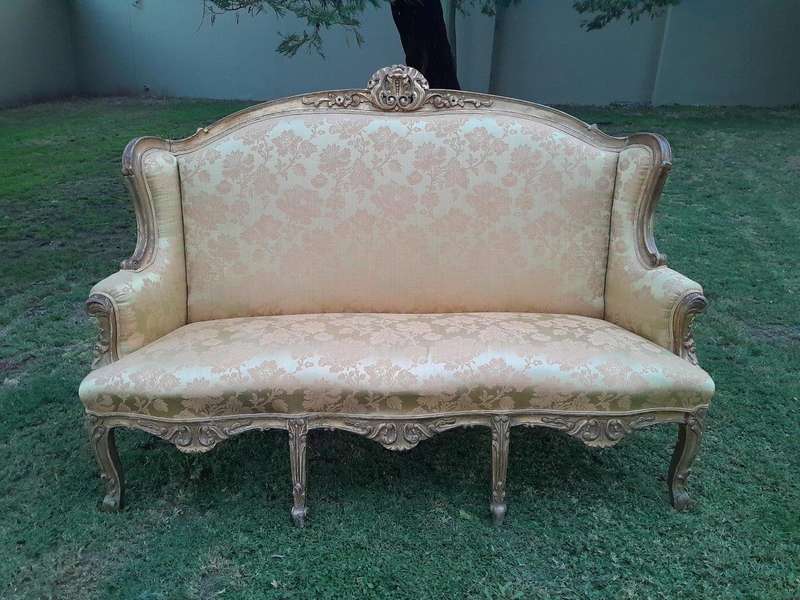 An Early 20th Century French Style Ornately Carved and Gilded Wingback Settee 