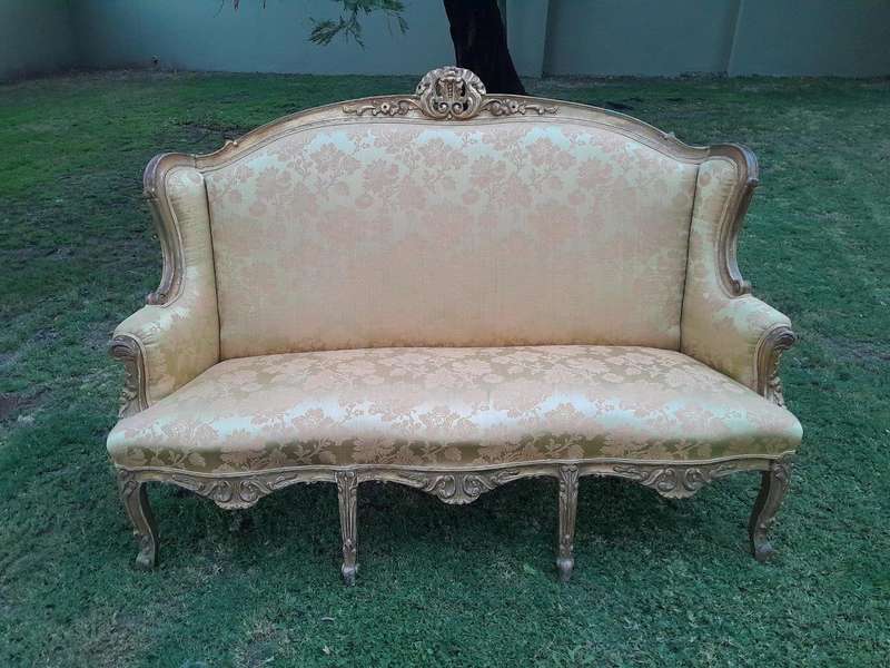 An Early 20th Century French Style Ornately Carved and Gilded Wingback Settee 