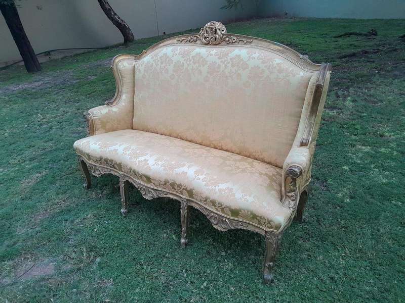 An Early 20th Century French Style Ornately Carved and Gilded Wingback Settee 