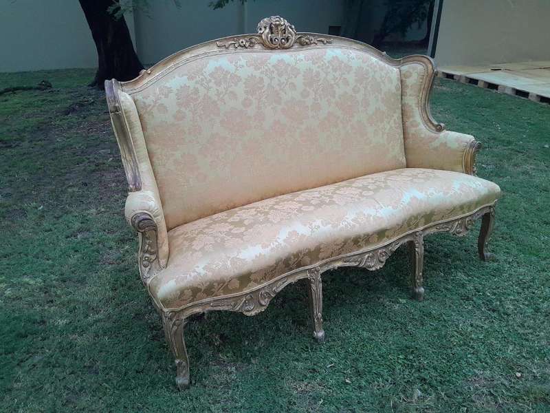 An Early 20th Century French Style Ornately Carved and Gilded Wingback Settee 