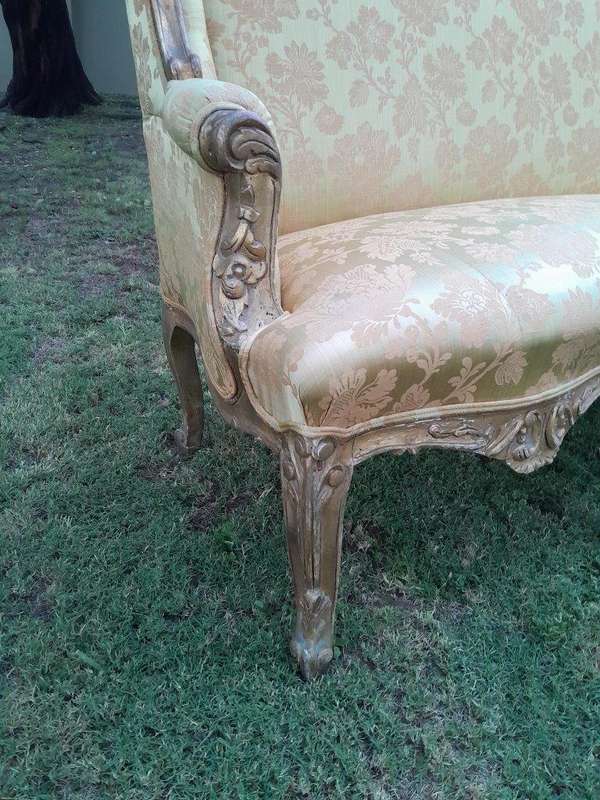 An Early 20th Century French Style Ornately Carved and Gilded Wingback Settee 