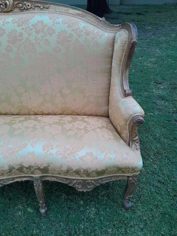 An Early 20th Century French Style Ornately Carved and Gilded Wingback Settee 