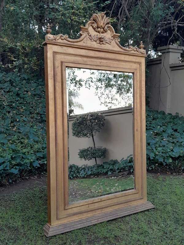 A Massive 20th Century French Style Ornately Carved and Gilded Bevelled Mirror