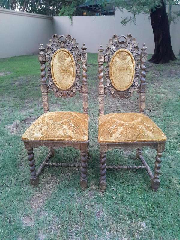 A Pair of 19th Century French Ornately Carved and Gilded Chairs
