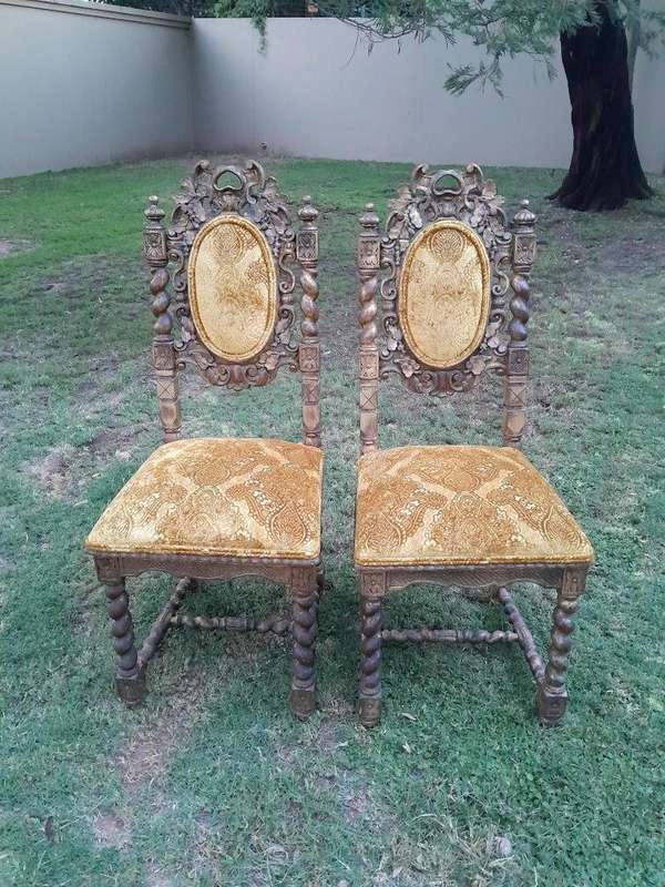 A Pair of 19th Century French Ornately Carved and Gilded Chairs