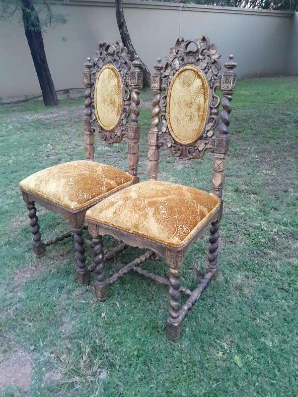 A Pair of 19th Century French Ornately Carved and Gilded Chairs