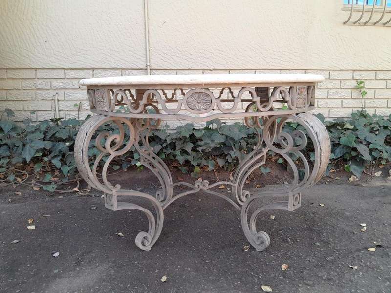 A 20th Century French Style Wrought Iron Circular Table with Cream Top