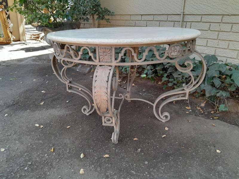 A 20th Century French Style Wrought Iron Circular Table with Cream Top