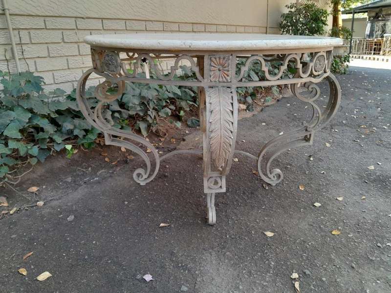 A 20th Century French Style Wrought Iron Circular Table with Cream Top