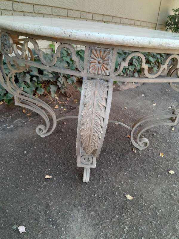 A 20th Century French Style Wrought Iron Circular Table with Cream Top