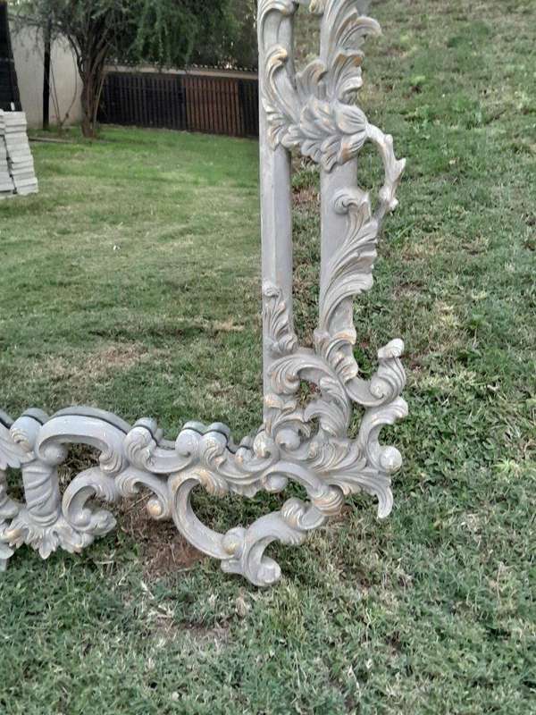A 20th Century French Style Carved Grey and Gilded Mirror