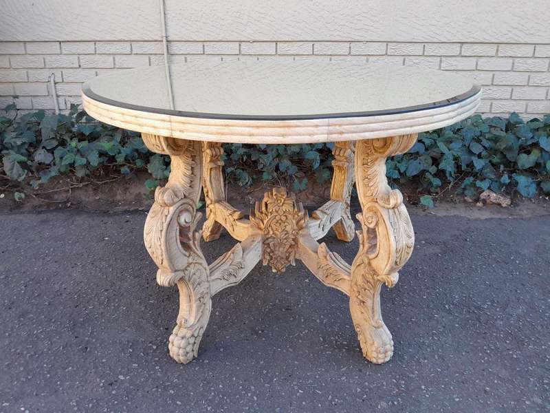 A 20th Century Ornately Carved Circular Wooden Table In A Contemporary Bleached Finish And With A...