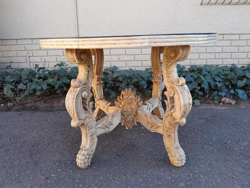 A 20th Century Ornately Carved Circular Wooden Table In A Contemporary Bleached Finish And With A...