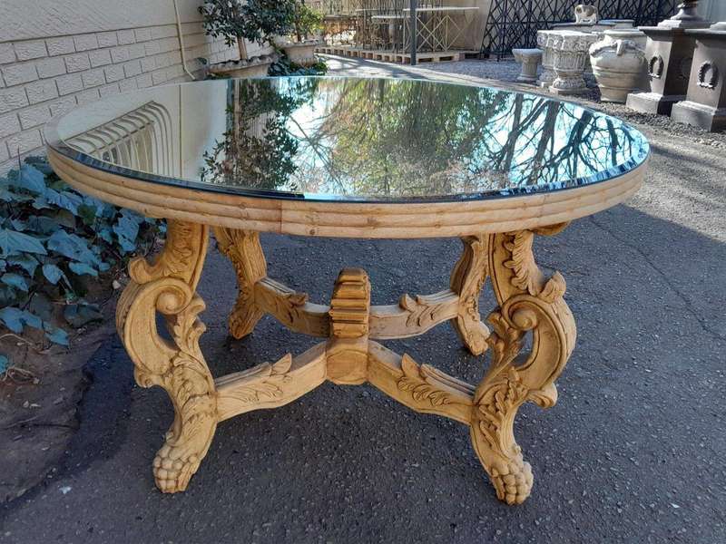 A 20th Century Ornately Carved Circular Wooden Table In A Contemporary Bleached Finish And With A...