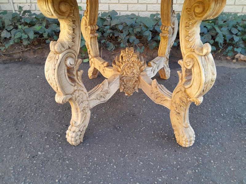 A 20th Century Ornately Carved Circular Wooden Table In A Contemporary Bleached Finish And With A...