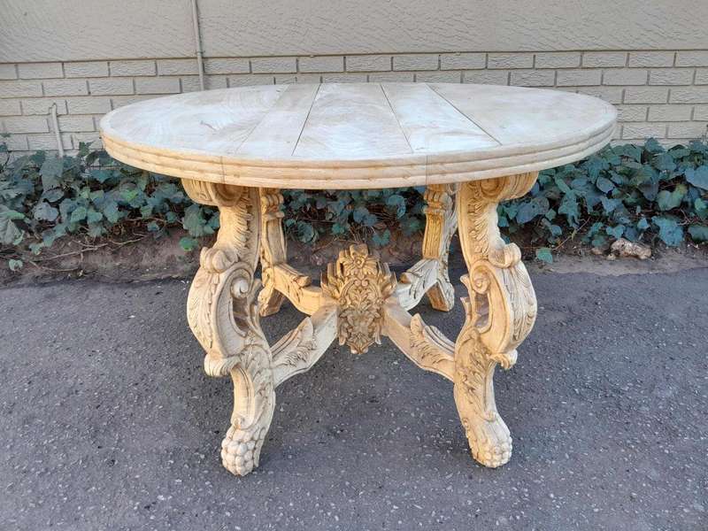 A 20th Century Ornately Carved Circular Wooden Table In A Contemporary Bleached Finish And With A...