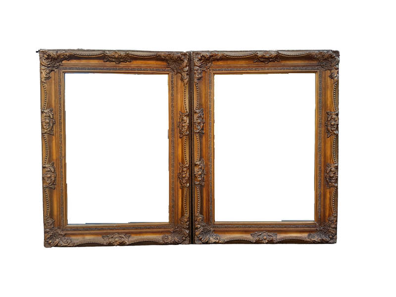 A 20th Century French Style Pair of Large and Ornately Carved Giltwood Mirrors