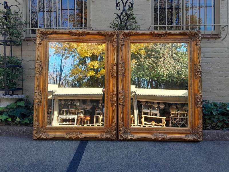 A 20th Century French Style Pair of Large and Ornately Carved Giltwood Mirrors