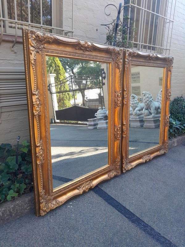 A 20th Century French Style Pair of Large and Ornately Carved Giltwood Mirrors