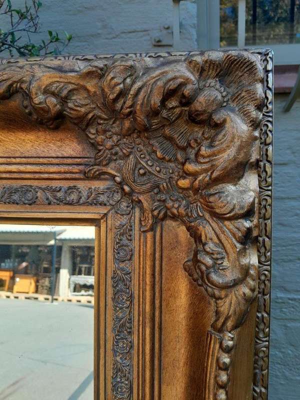 A 20th Century French Style Pair of Large and Ornately Carved Giltwood Mirrors