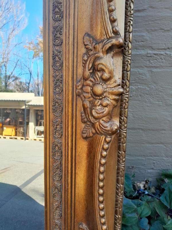 A 20th Century French Style Pair of Large and Ornately Carved Giltwood Mirrors