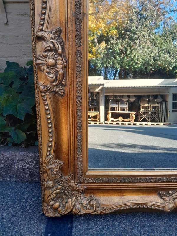 A 20th Century French Style Pair of Large and Ornately Carved Giltwood Mirrors