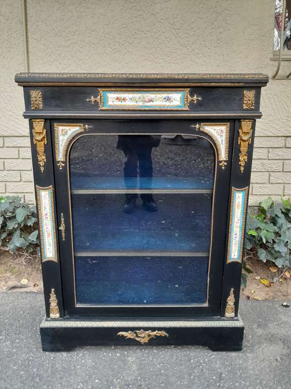 A 19th Century French Ebonised Pier Cabinet And Ormolu Mounts And Porcelain