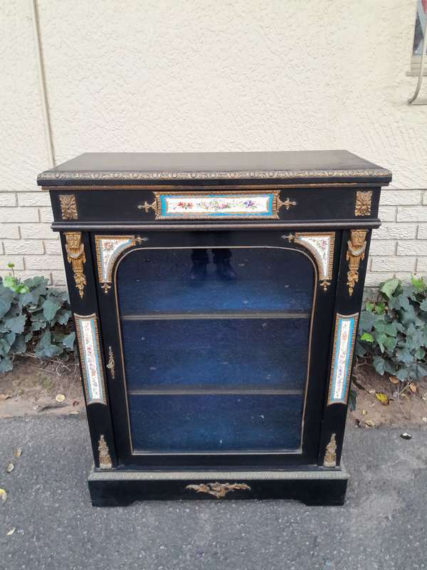 A 19th Century French Ebonised Pier Cabinet And Ormolu Mounts And Porcelain