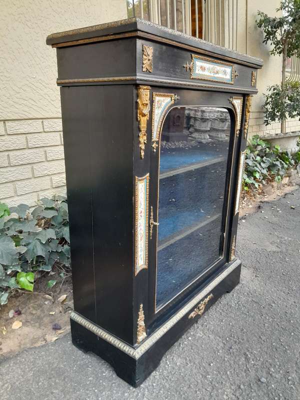 A 19th Century French Ebonised Pier Cabinet And Ormolu Mounts And Porcelain