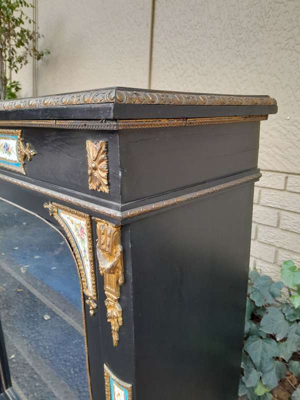 A 19th Century French Ebonised Pier Cabinet And Ormolu Mounts And Porcelain