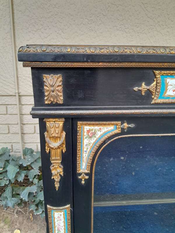A 19th Century French Ebonised Pier Cabinet And Ormolu Mounts And Porcelain