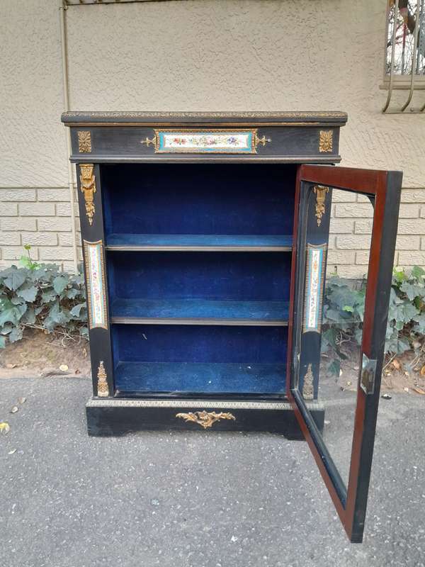 A 19th Century French Ebonised Pier Cabinet And Ormolu Mounts And Porcelain