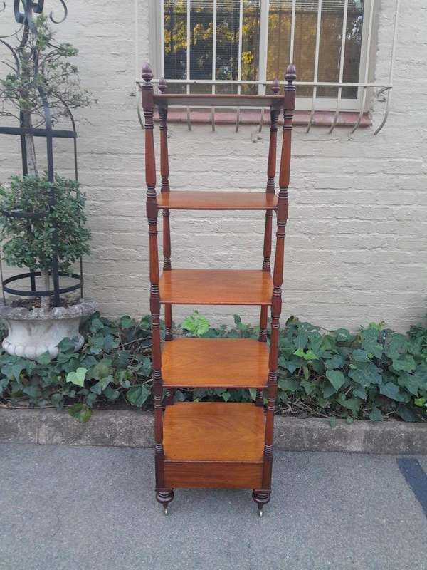 A 20th Century Mahogany Display Stand With Castors