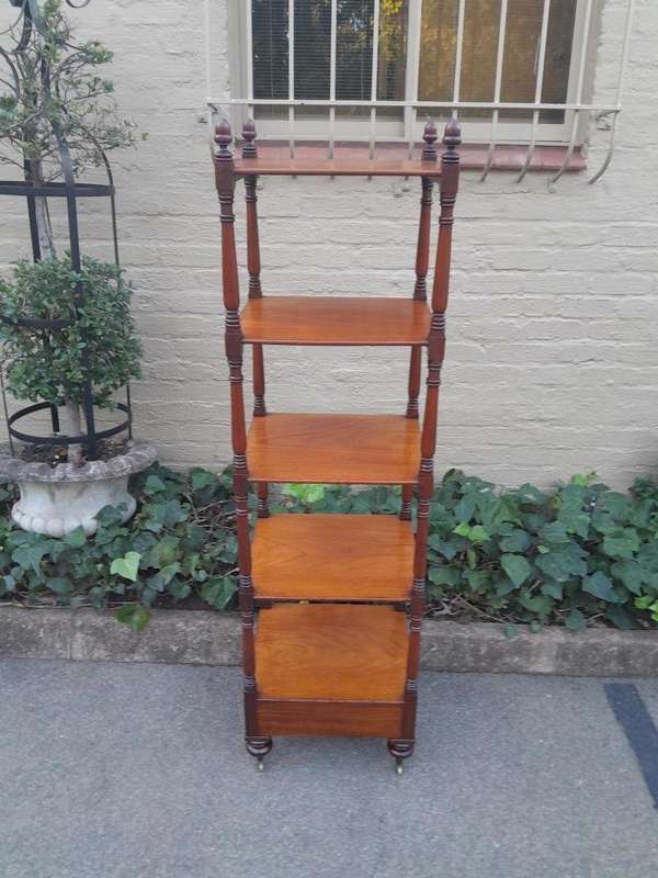 A 20th Century Mahogany Display Stand With Castors