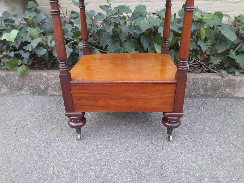 A 20th Century Mahogany Display Stand With Castors