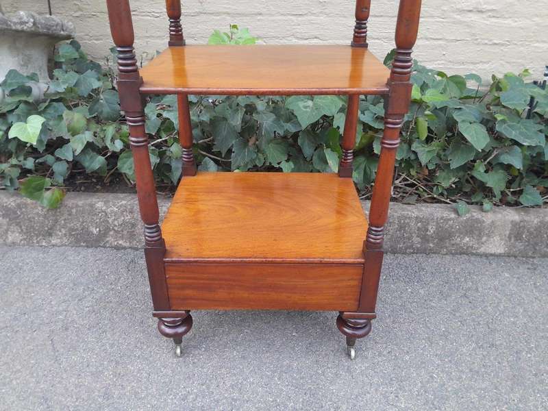 A 20th Century Mahogany Display Stand With Castors