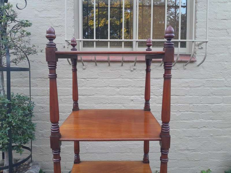 A 20th Century Mahogany Display Stand With Castors